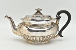 AN EDWARDIAN SILVER TEAPOT, oval form with a polished and stop reeded pattern, engraved crest