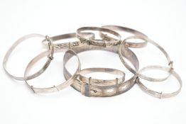 A SELECTION OF MAINLY CHILD'S SILVER AND WHITE METAL BANGLES, to include eight expandable child's