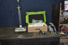 A G TECH AIR RAM UPRIGHT VACUUM CLEANER and a handheld vacuum with some accessories and one