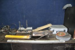 A VINTAGE OAK LEG VICE, an aluminium case, a mitre saw, various grinding discs, etc