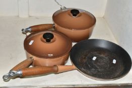 THREE LE CREUSET CAST IRON COOKWARES, comprising 20cm and 22cm saucepans with lids and a 26cm frying