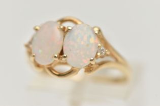 A MODERN YELLOW METAL OPAL AND DIAMOND DRESS RING, set with two oval opal cabochons, claw set,