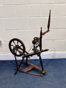 A VICTORIAN STAINED BEECH SPINNING WHEEL (condition report: leather strap broken