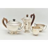 A GEORGE V SILVER FOUR PIECE TEA SET, comprising of a teapot, coffee pot, each fitted with wooden