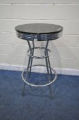 A MODERN TALL CIRCULAR POSEUR TABLE, with a black painted wooden top, on shaped tubular legs,