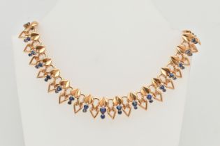 A DECORATIVE SAPPHIRE NECKLACE, designed as a line of heart shape panels each suspending two