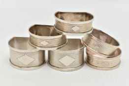 THREE PAIRS OF SILVER NAPKIN RINGS, to include a pair of circular engine turned pattern napkin rings