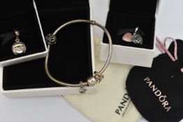 A BOXED 'PANDORA' CHARM BRACELET AND TWO BOXED CHARMS, snake chain bracelet fitted with a signed '