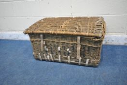 A WICKER BASKET, with a hinged lid and two closing belts, width 81cm x depth 54cm x height 58cm (