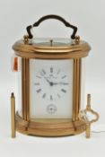 A 'MATTHEW NORMAN' BRASS REPEATER CARRIAGE CLOCK, oval form, key wound, rectangular white dial