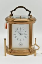 A 'MATTHEW NORMAN' BRASS REPEATER CARRIAGE CLOCK, oval form, key wound, rectangular white dial