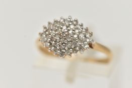 A 9CT GOLD DIAMOND CLUSTER RING, designed as a tiered cluster of single cut diamonds in claw