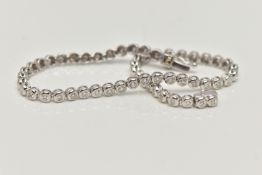A WHITE METAL DIAMOND LINE BRACELET, designed as fifty-six brilliant cut diamonds each in a rub