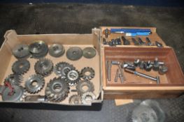 A BOX AND A TRAY CONTAINING MILLING HEAD CUTTERS