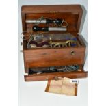 A HAND OPERATED ELECTROTHERAPY MACHINE, in a wooden case, with accessories and 'Brief Directions for