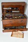 A HAND OPERATED ELECTROTHERAPY MACHINE, in a wooden case, with accessories and 'Brief Directions for