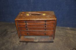 A VINTAGE WOODEN ENGINEERS TOOLCHEST with lock to front (no key), concealing five graduated