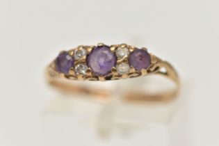 A 9CT GOLD AMETHYST AND CUBIC ZIRCONIA RING, set with three circular cut amethysts, flanked with