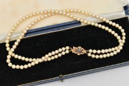 A DOUBLE CULTURED PEARL STRAND NECKLACE, double row of cultured cream pearls with a pink hue, each