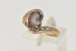 A 9CT GOLD MYSTIC TOPAZ AND DIAMOND RING, centring on an oval cut mystic topaz, four claw set,