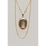 A 9CT GOLD OVAL LOCKET AND CHAIN, bi-colour oval locket with foliate pattern, opens to reveal two