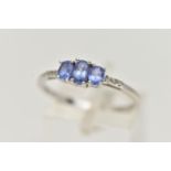 A 14CT WHITE GOLD TANZANITE AND DIAMOND RING, three oval cut tanzanite, each four claw set, small