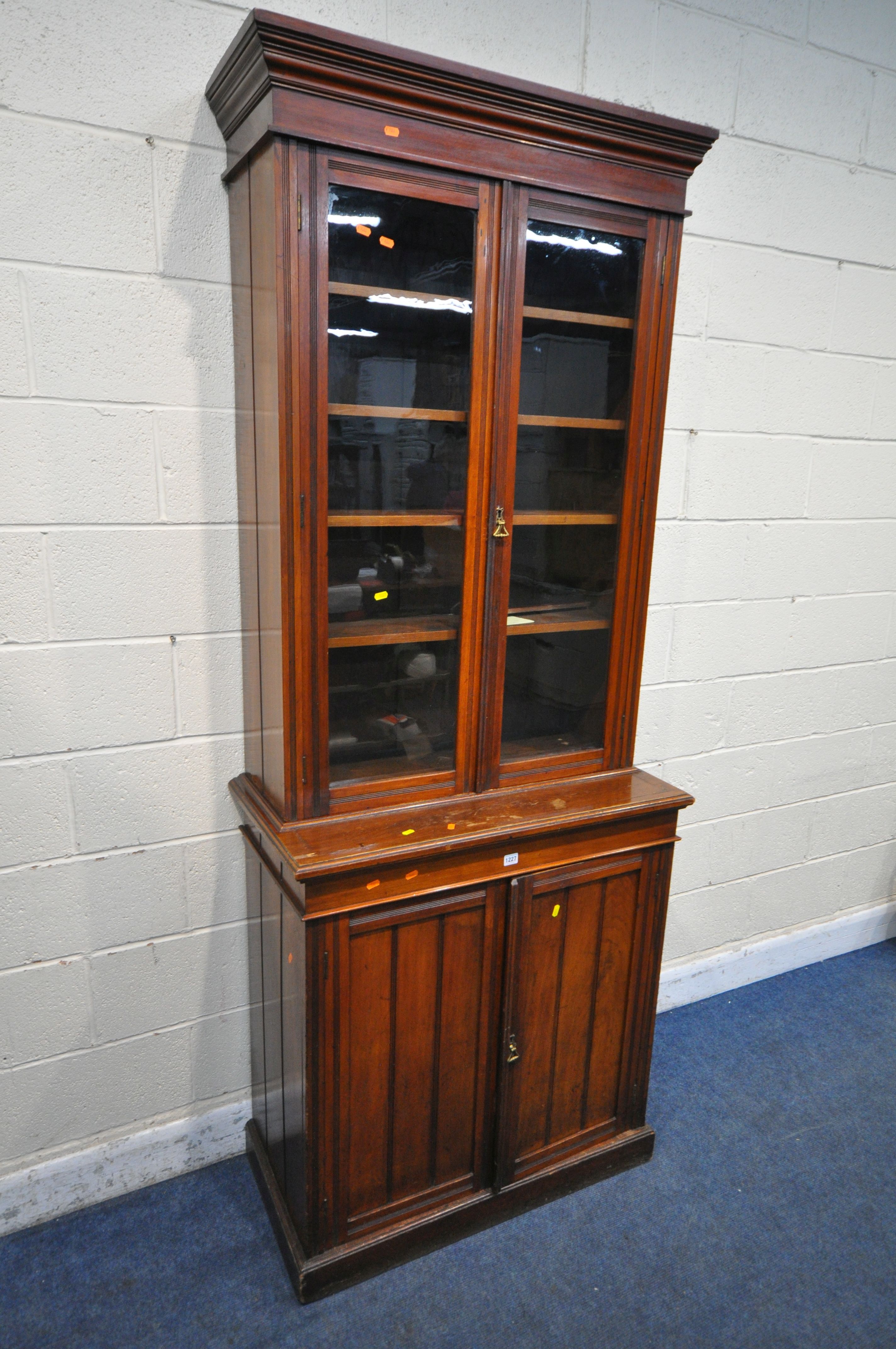 A 20TH CENTURY MAHOGANY BOOKCASE, fitted with double glazed doors and double cupboard doors,