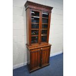 A 20TH CENTURY MAHOGANY BOOKCASE, fitted with double glazed doors and double cupboard doors,