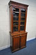 A 20TH CENTURY MAHOGANY BOOKCASE, fitted with double glazed doors and double cupboard doors,