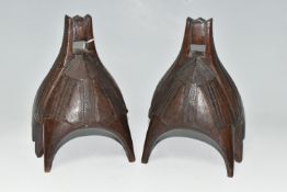 A PAIR OF WOODEN STIRRUPS, carved with patterns, each with six wooden 'legs', approximate