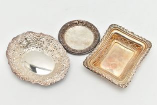 THREE SILVER BONBON DISHES, the first of an oval floral and foliate embossed design, hallmarked '