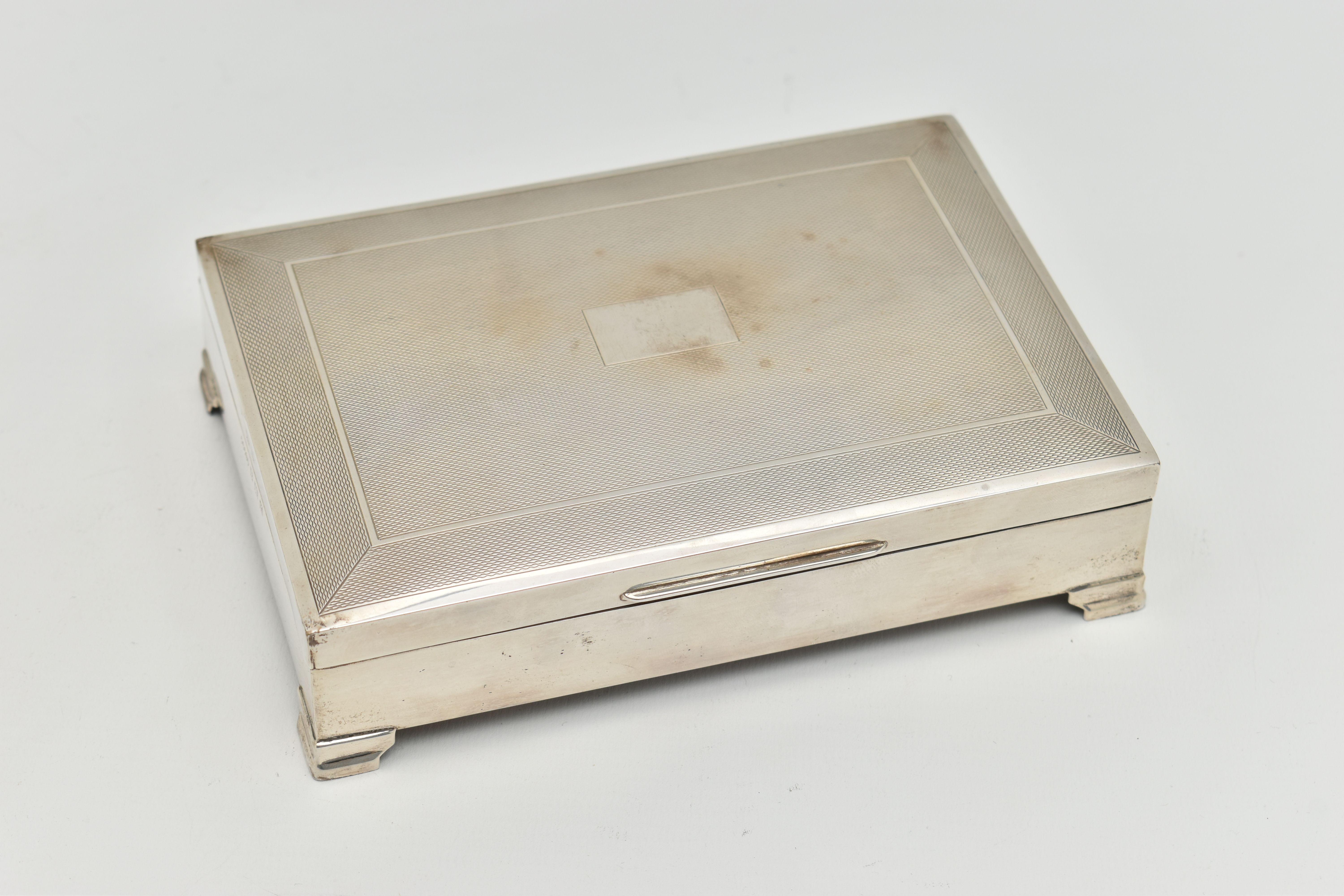 AN ELIZABETH II SILVER CIGARETTE BOX, rectangular engine turned pattern box with vacant cartouche,