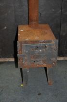 A 'WILDO' SOLID FUEL WORKSHOP STOVE with 155cm flue, fire box width 30cm depth 45cm height on legs