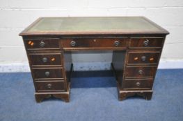 A 20TH CENTURY MAHOGANY TWIN PEDESTAL DESK, with green tooled leather writing surface, fitted with