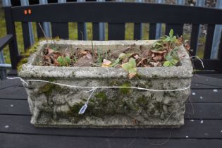 A WEATHERED COMPOSITE RECTANGULAR PLANTER, depicting putto to the sides, length 54cm (condition