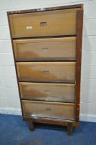 A GOVERNMENT ISSUE STAVERTON OAK BOOKCASE, with five rise and fall doors, enclosing an arrangement