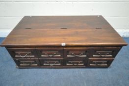 A RECTANGULAR HARDWOOD COFFEE TABLE, with a hinged storage compartment and eight drawers, with