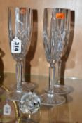 FOUR MARQUIS BY WATERFORD CHAMPAGNE FLUTES AND A SWAROVSKI CRYSTAL HEDGEHOG, the Waterford glasses
