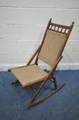 A 20TH CENTURY FOLDING ROCKING CHAIR, with beige fabric back and seat (condition report: surface