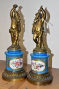 A PAIR OF NINETEENTH CENTURY CONTINENTAL PORCELAIN AND GILT METAL FORMER CANDLEHOLDERS, the hand