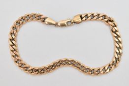 A YELLOW METAL CURB LINK BRACELET, hollow links, fitted with a lobster clasp, stamped 9kt, length