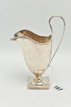 AN EDWARDIAN BRITANNIA STANDARD SILVER HELMET SHAPED CREAM JUG, beaded rim, strap handle, short