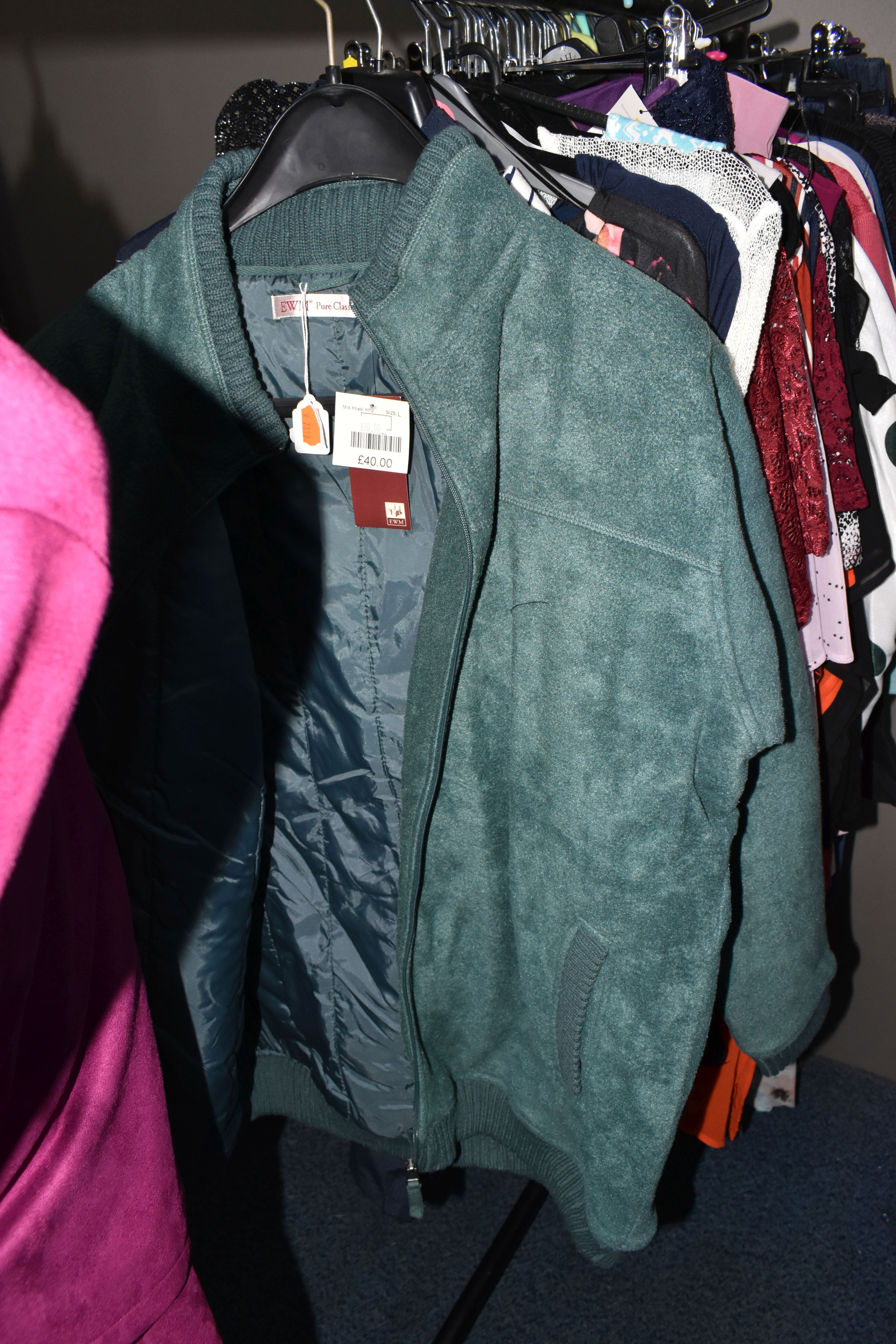 A QUANTITY OF MODERN UNUSED LADIES' CLOTHING, to include a brown leather jacket, black faux fur, - Image 9 of 27