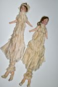 TWO BISQUE HEAD DOLL PARASOLS, doll heads with composition lower limbs, hands and feet (in leather