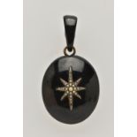 A LATE VICTORIAN JET AND SEED PEARL PENDANT, of oval outline with central elongated star set with