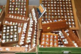 A LARGE COLLECTION OF PORCELAIN THIMBLES, to include fourteen wooden thimble display stands and over