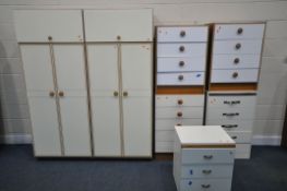 A MATCHED BEDROOM SUITE, comprising two double door wardrobes with top compartments, width 77cm x