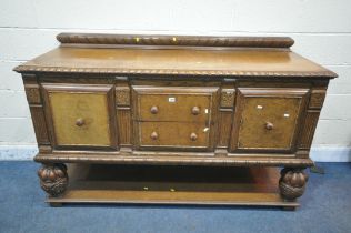AN EARLY 20TH CENTURY OAK SIDEBOARD, with a raised back, two drawers, two cupboard doors, on acorn