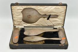 A CASED SILVER VANITY SET, to include four brushes and a mirror (comb is missing), engine turned