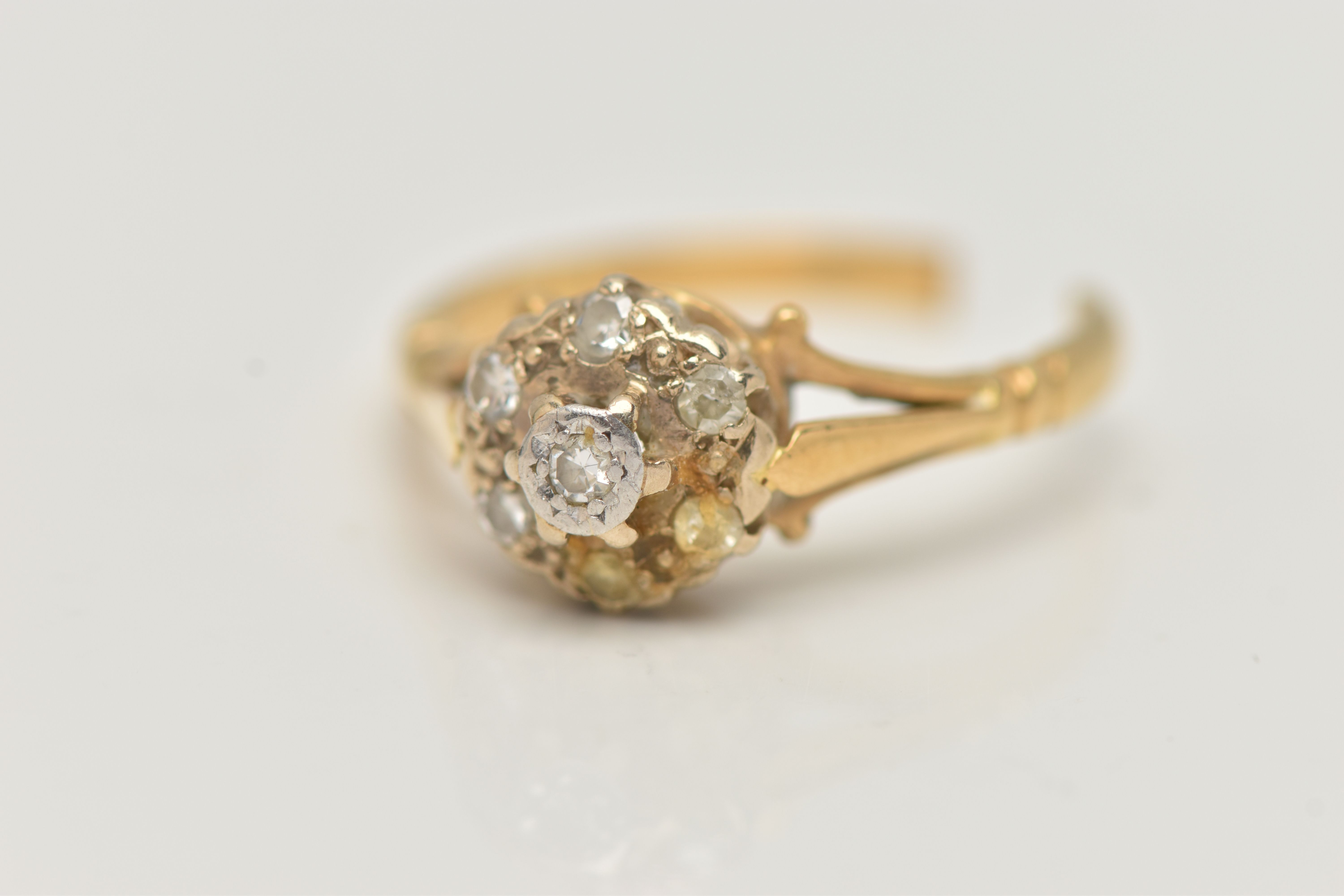 A DIAMOND CLUSTER RING, AF, designed as a two tier cluster of single cut diamonds to the trifurcated